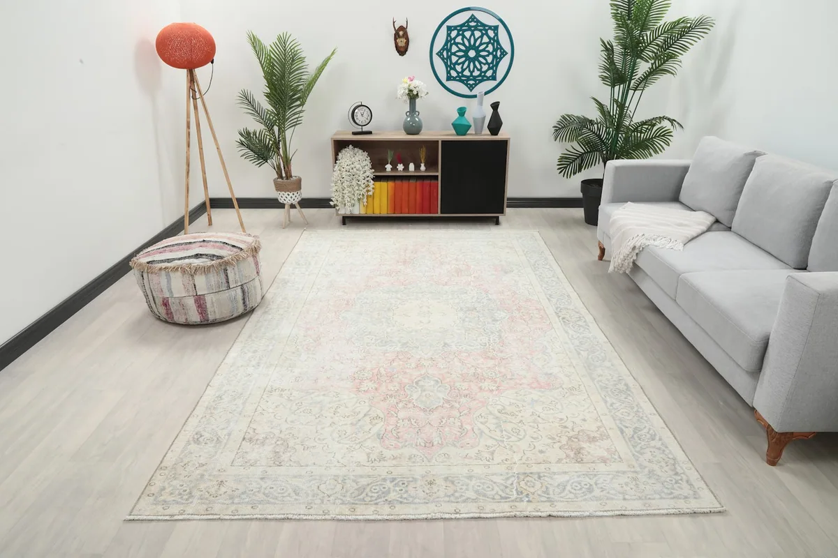 Vintage Anatolian rug in a living room setting, showing its scale relative to a sofa and furniture