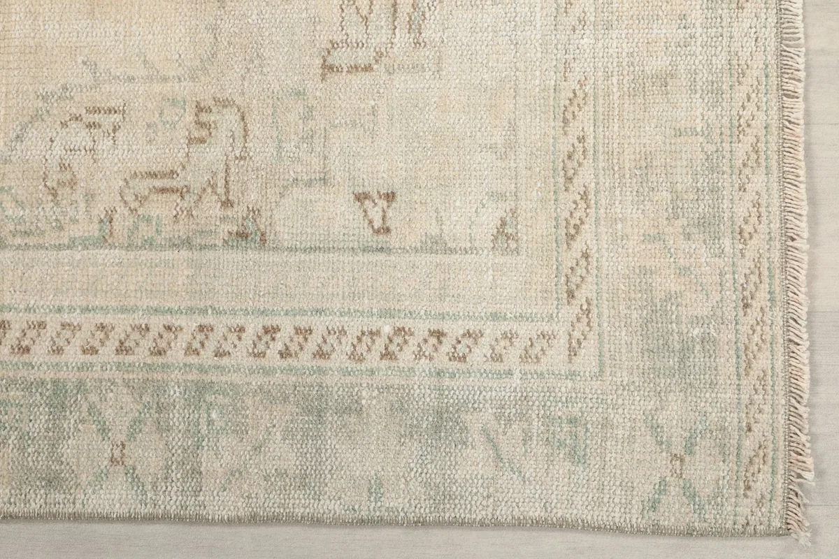 Detailed view of the green and brown border patterns and subtle corner motifs