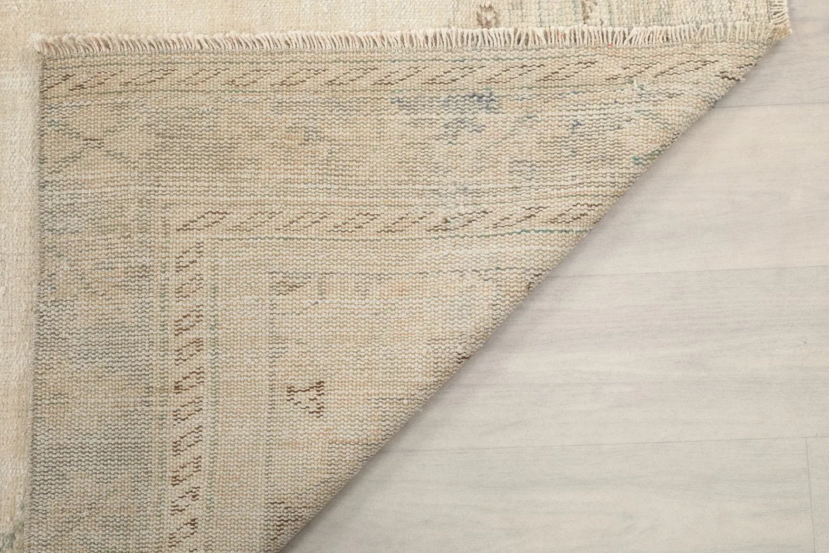 Close-up of the folded corner, showing the rug's structure and fringe