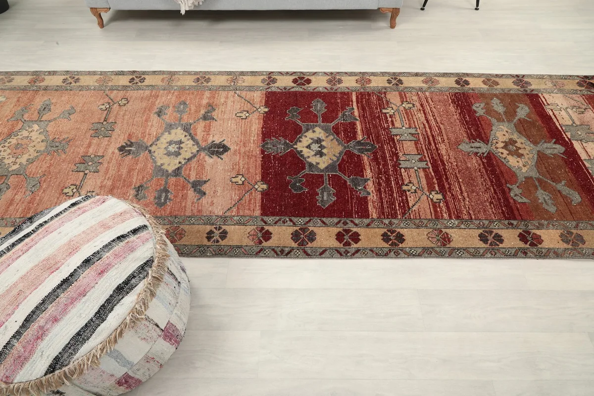 Overhead angle of the runner rug, emphasizing the transition between red and beige sections