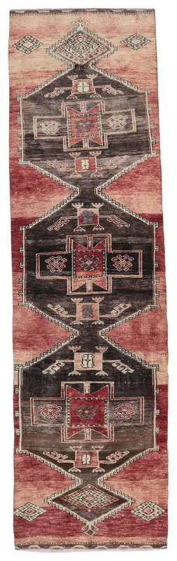 Full overhead view of the vintage Anatolian runner rug with rust and charcoal geometric patterns.