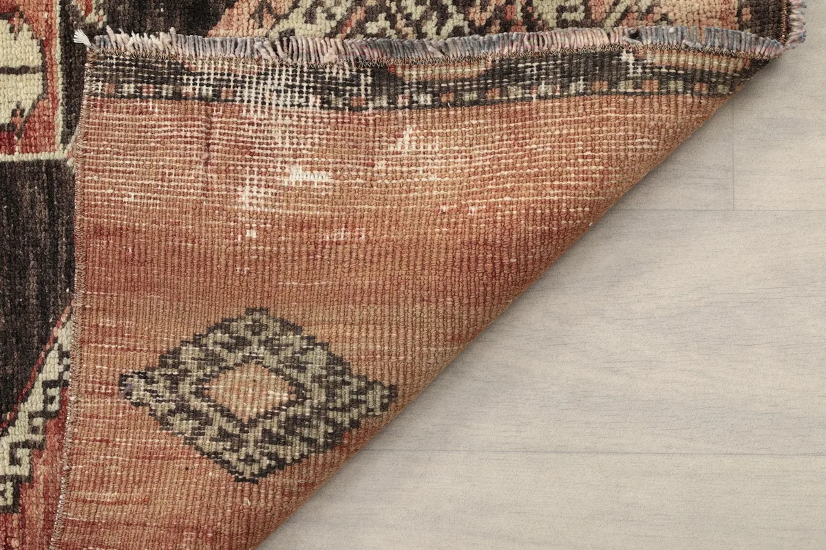 Another view of the rug's reverse side, detailing the tightly woven cotton foundation.