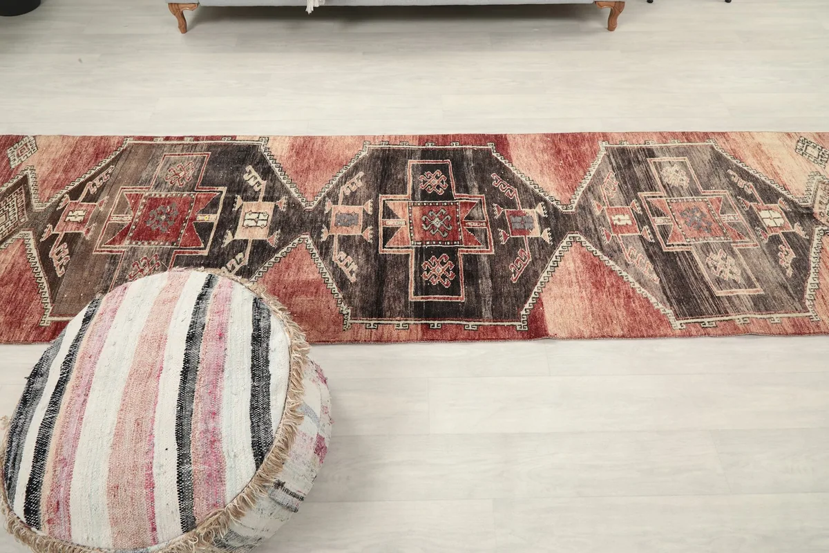 Full overhead view of the runner rug in a room setting, showing its long shape.