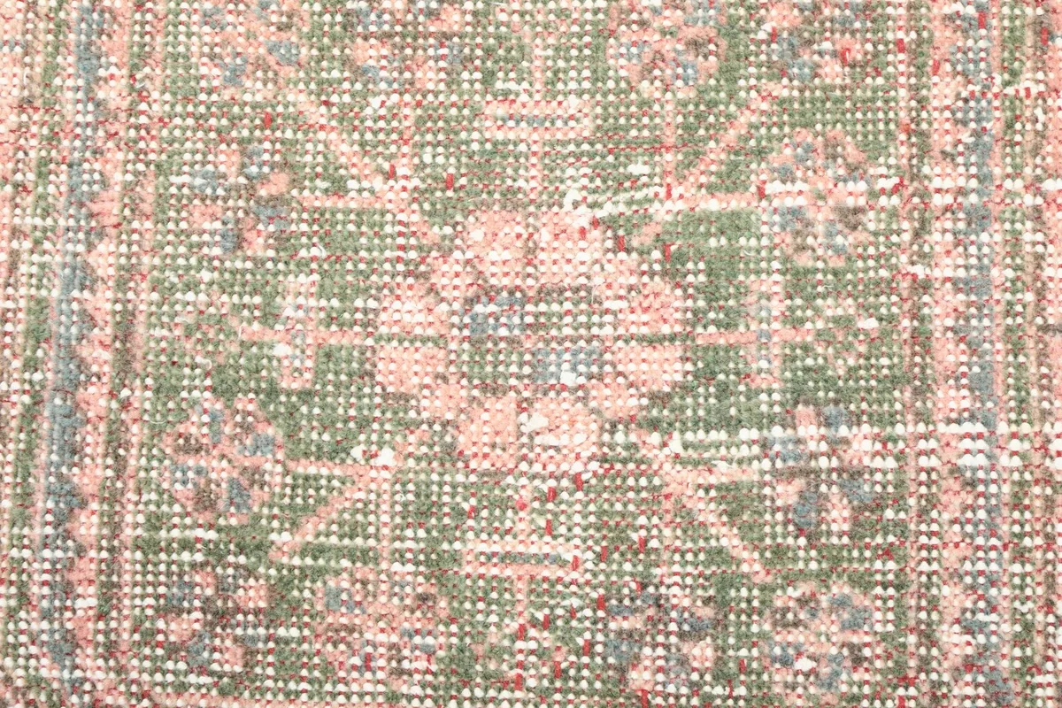 Extreme close-up of the hand-knotted wool pile, showing the texture and color variations.