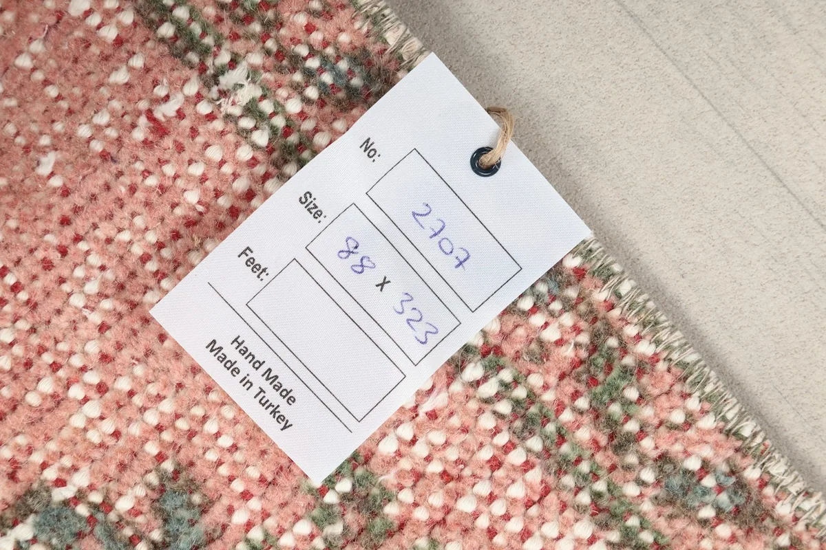 Rug tag displaying the dimensions and origin of the hand-knotted Anatolian runner.