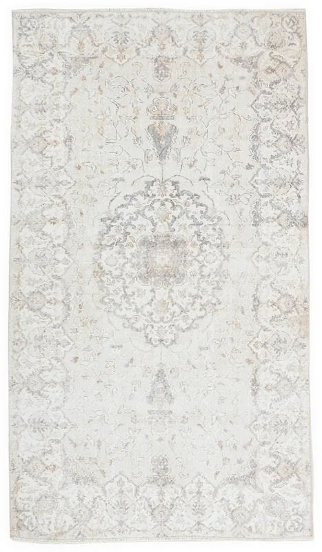 Full overhead view of an ivory and gray vintage Anatolian rug with a central medallion.