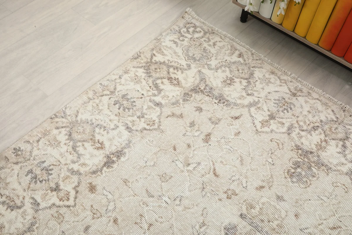Corner detail of the rug, illustrating the subtle colors and patterns.