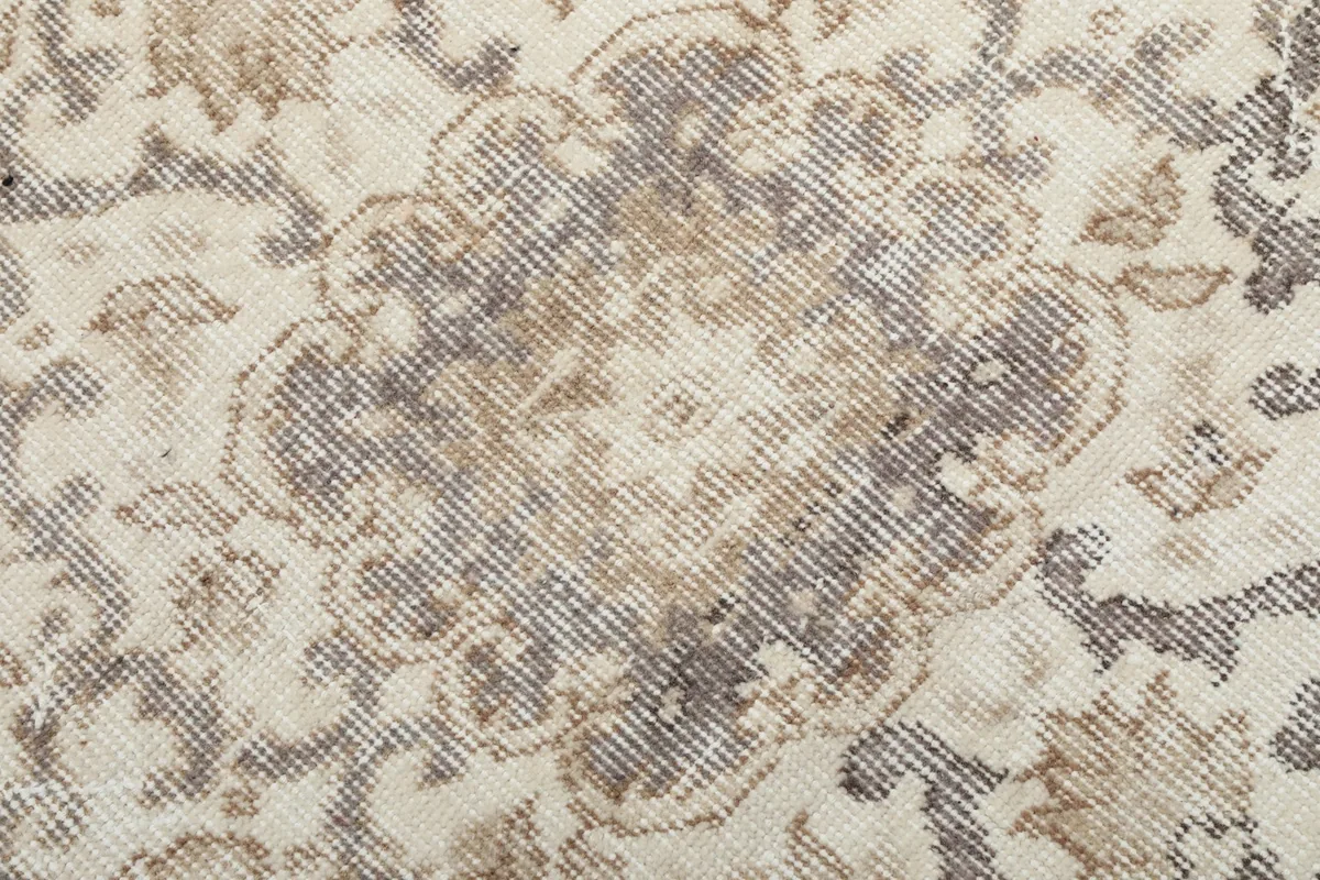 Extreme close-up of the central medallion, showing the intricate hand-knotted wool pile.