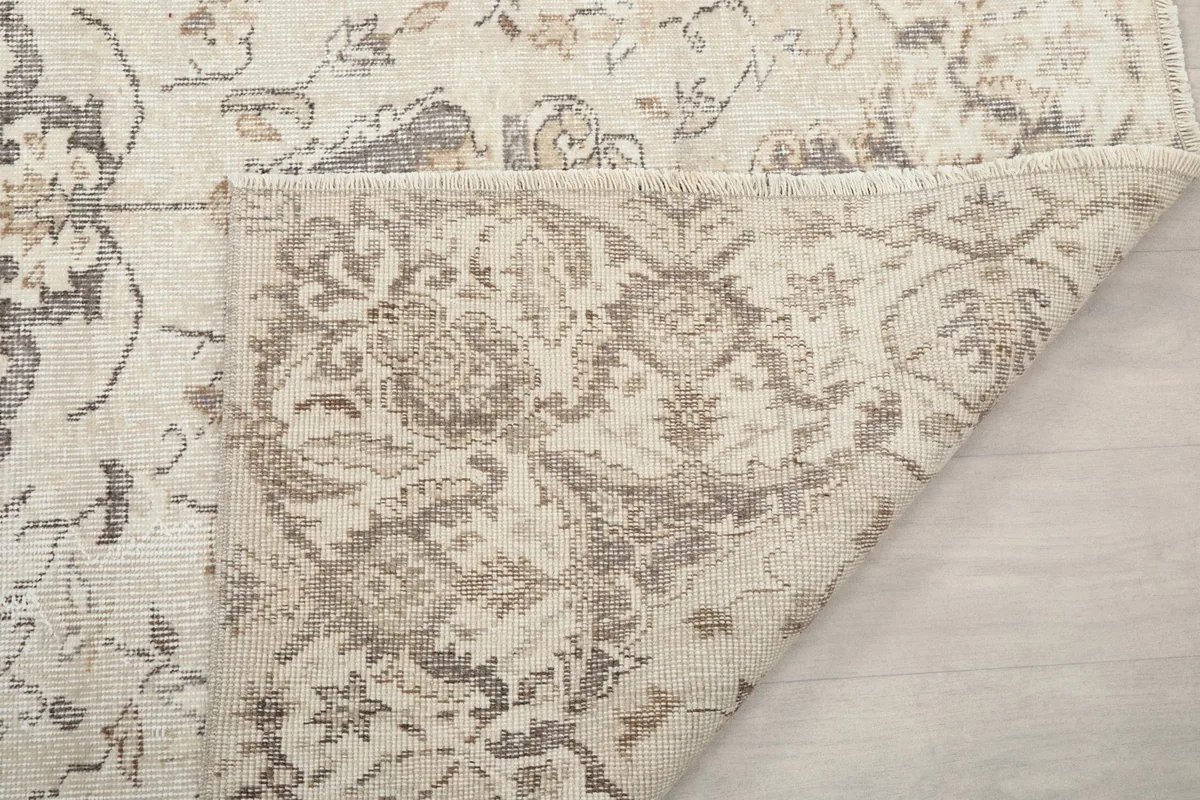 Detail of the rug's reverse side, revealing the hand-knotted construction and foundation.