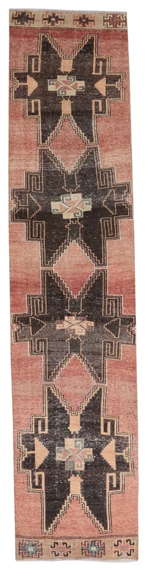 Full overhead view of the rust and black geometric Anatolian runner on a white background.