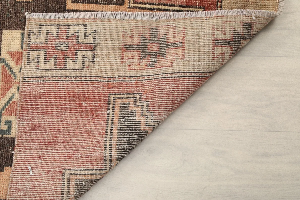 Angled view of the rug's reverse side, showing the tightly woven knots and construction.