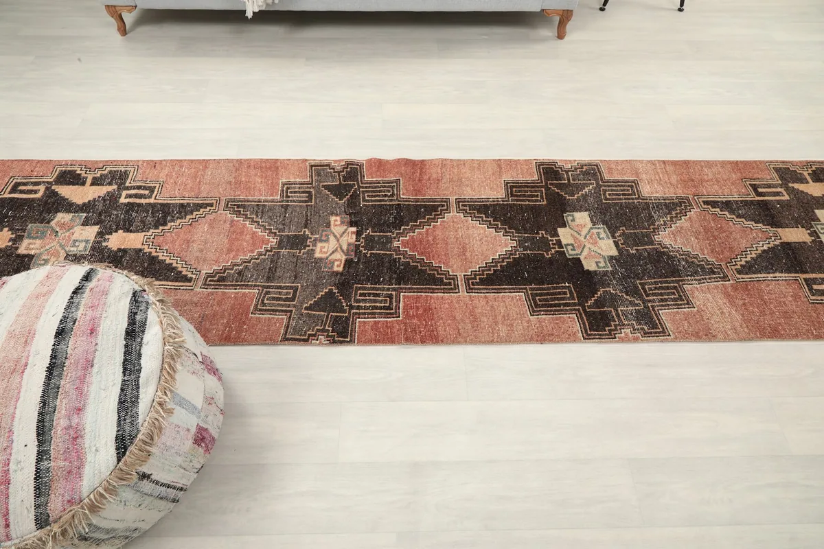 Overhead view of the full runner rug in a room setting, emphasizing its elongated shape.