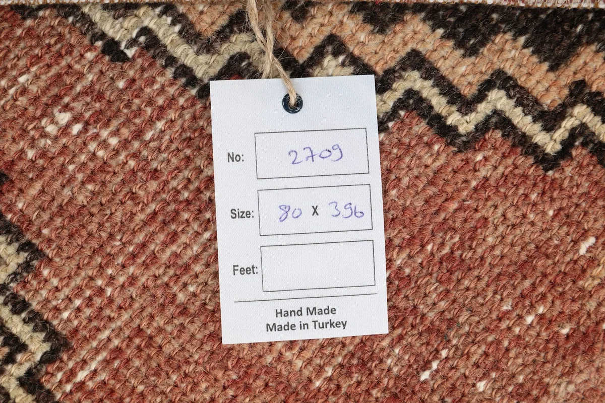 Close-up of the rug's label, confirming its origin and hand-made quality.