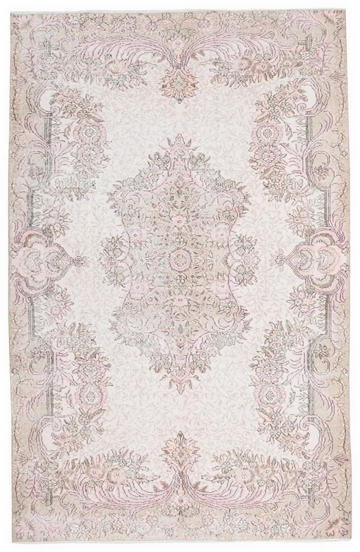 Full top view of the ivory and rose floral medallion vintage Anatolian rug