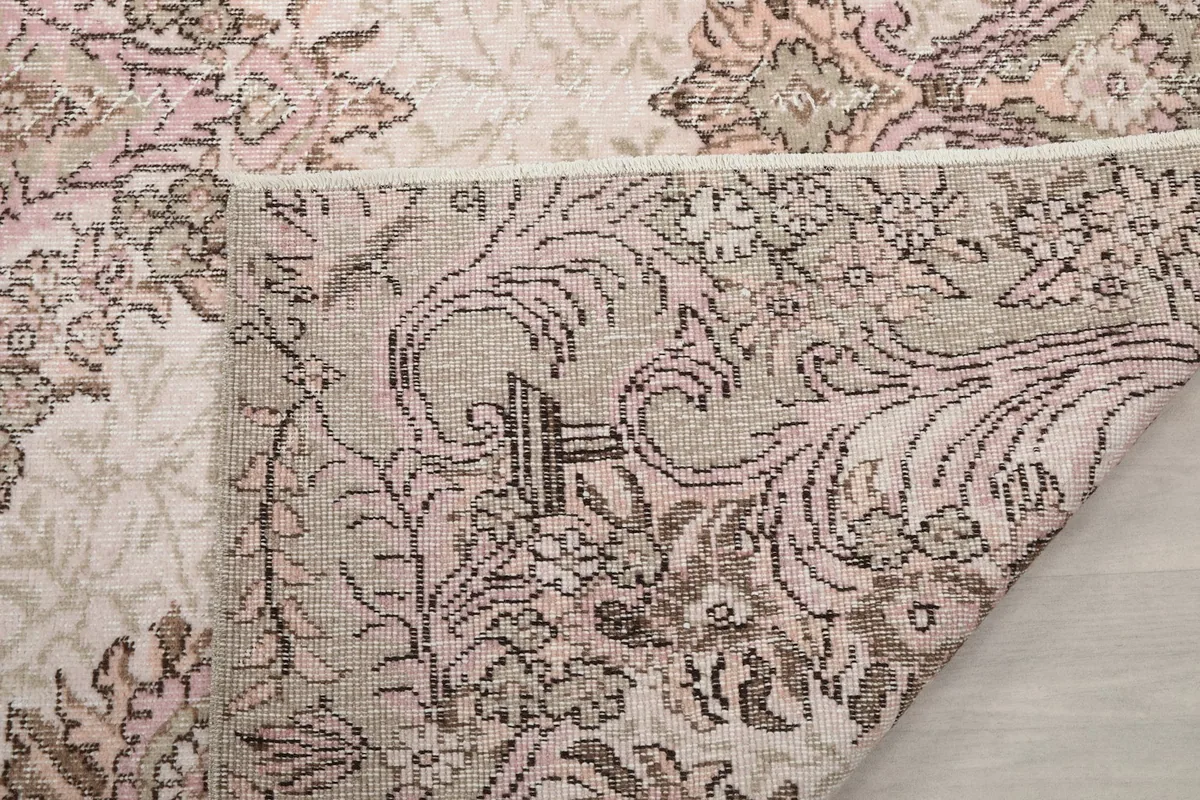 Close-up of the rug's back, showing the tight knotting and wool pile on cotton foundation