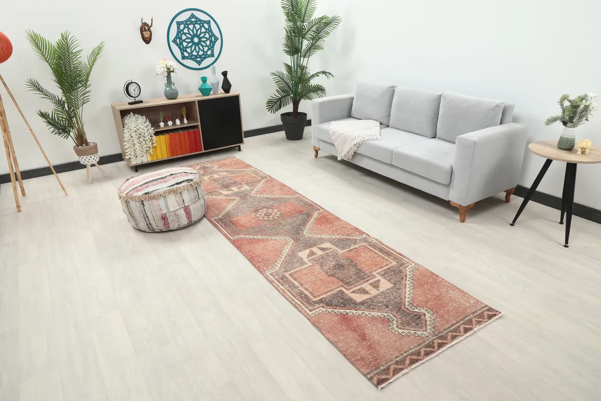 Rust Gray Geometric Anatolian Runner in a living room, angled view showing its length next to a sofa.
