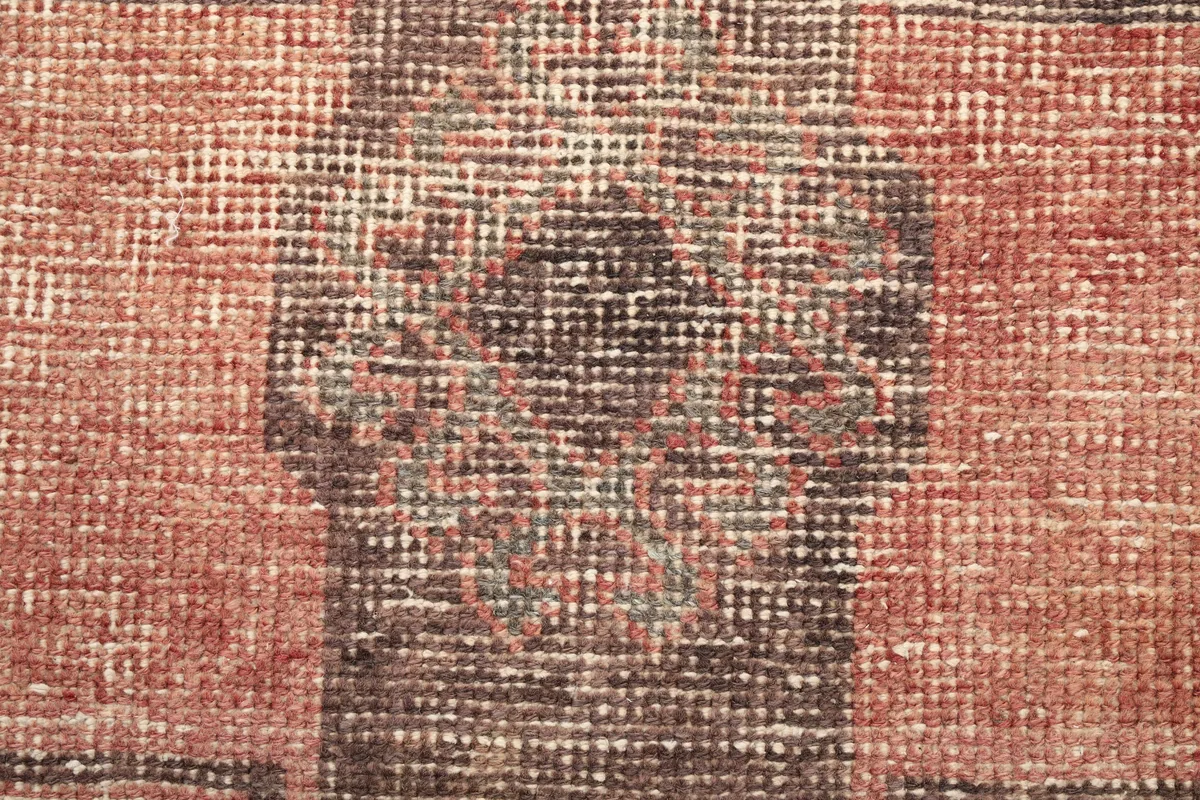 Close-up of the low pile and texture, showing the individual knots and color variations in the runner.