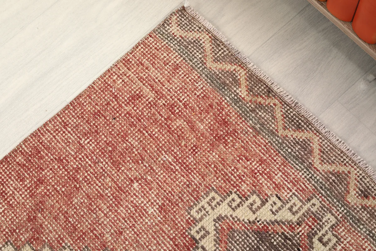 Corner detail of the Rust Gray Geometric Anatolian Runner, showing the fringe and border design.