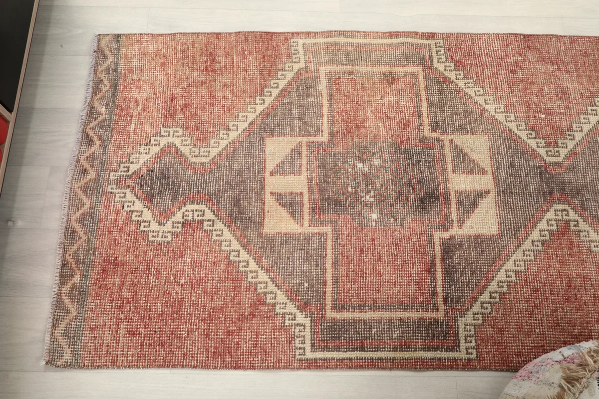 Angled view of the Rust Gray Geometric Anatolian Runner, focusing on the central and end motifs.
