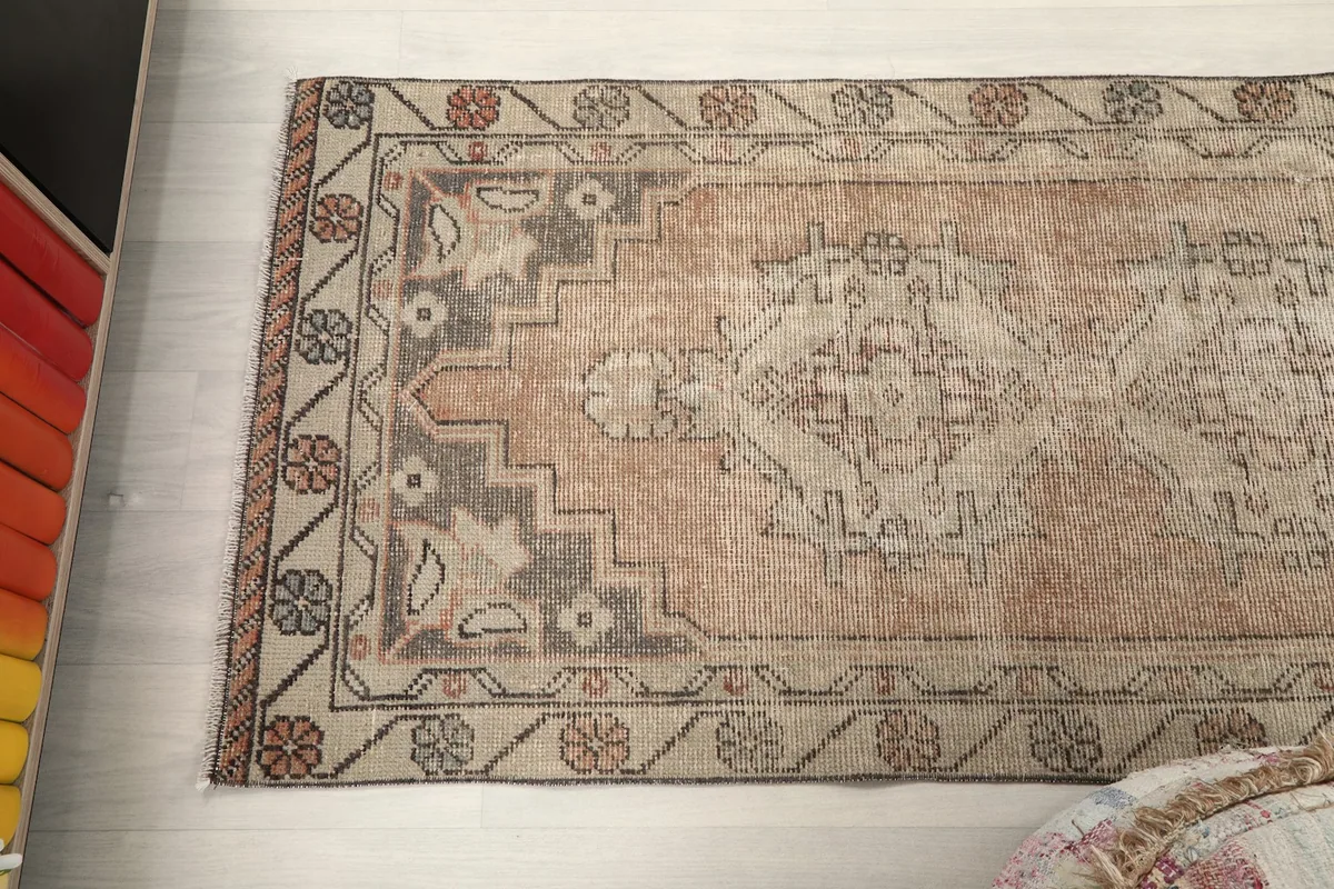 Angled view of the runner rug, focusing on the upper section and its patterns