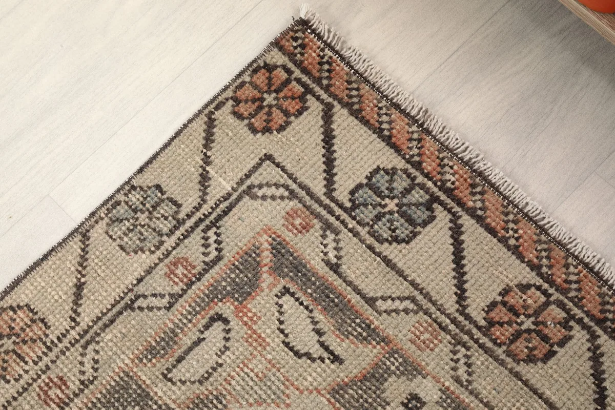Close-up of one corner of the rug, showing the detailed border and fringe