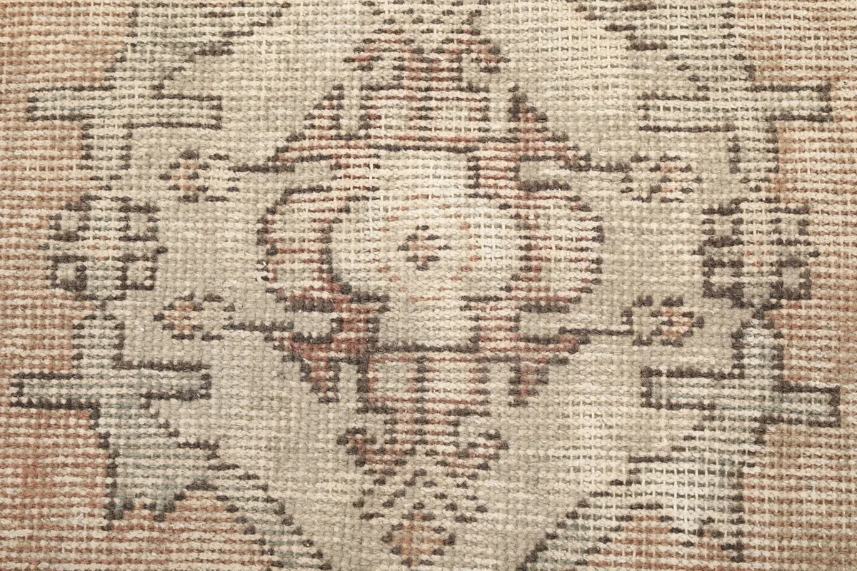 Close-up of the hand-knotted wool pile, showing texture and color variation