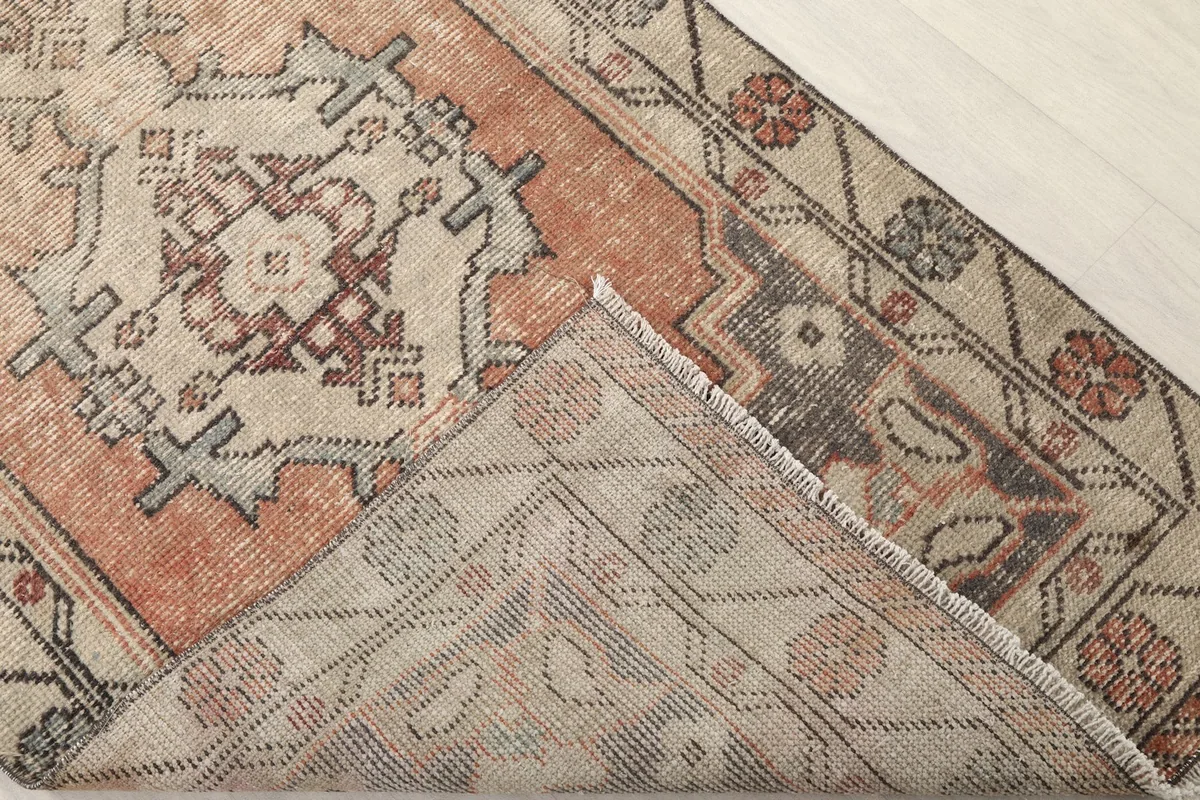 View of the back of the rug, showing the hand-knotted foundation and reverse pattern