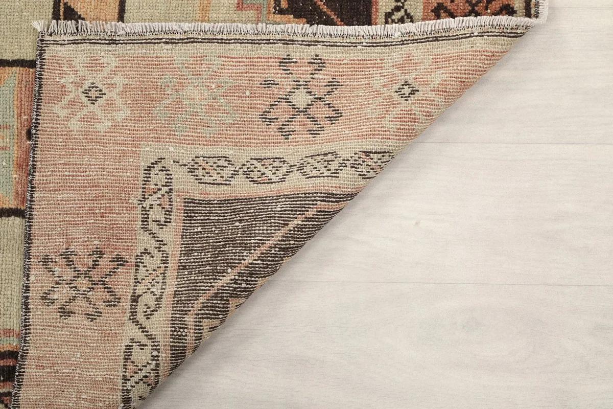 Underside of the rug showing the cotton foundation and hand-knotted details