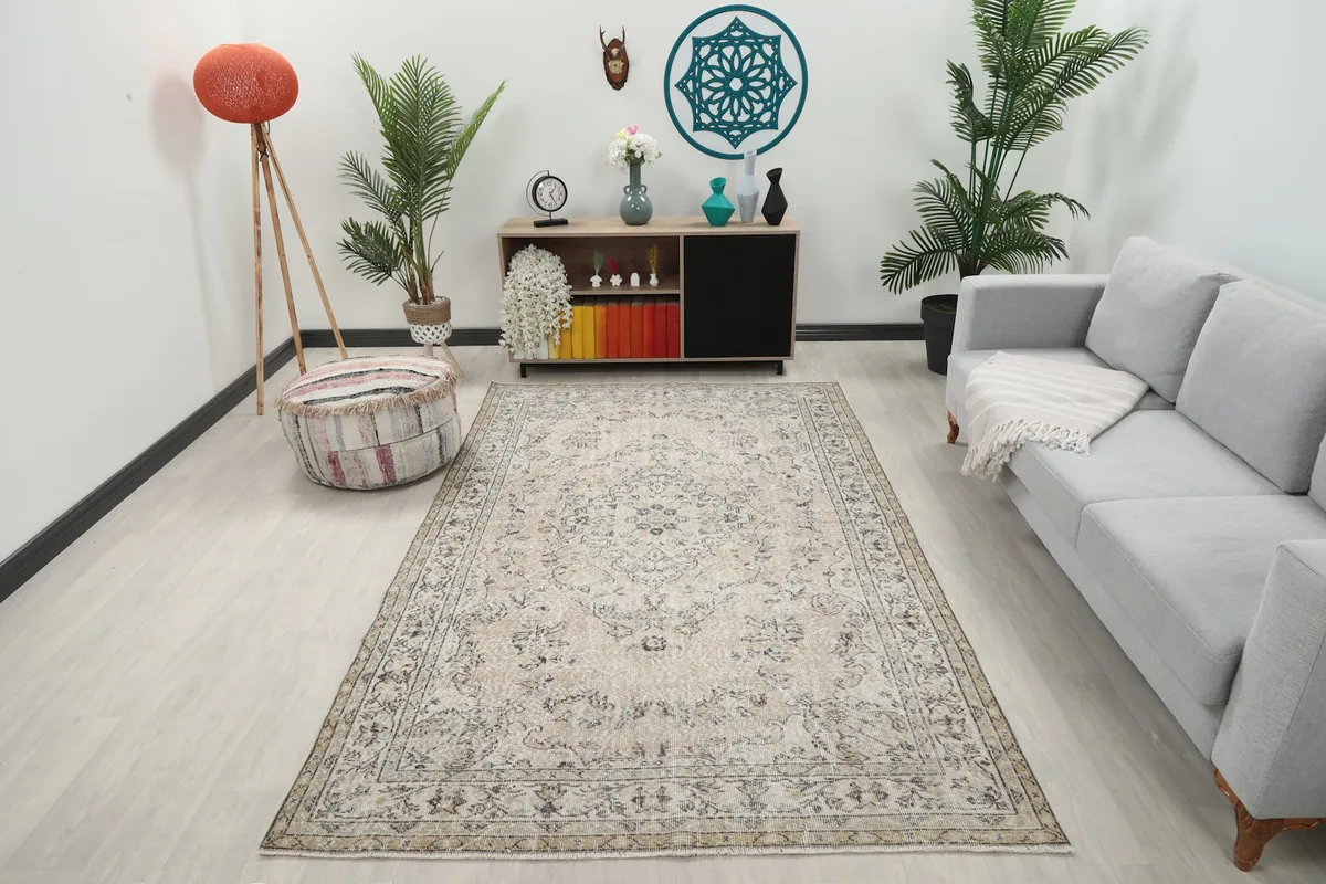 Ivory vintage rug displayed in a bright living room setting with a sofa and plants