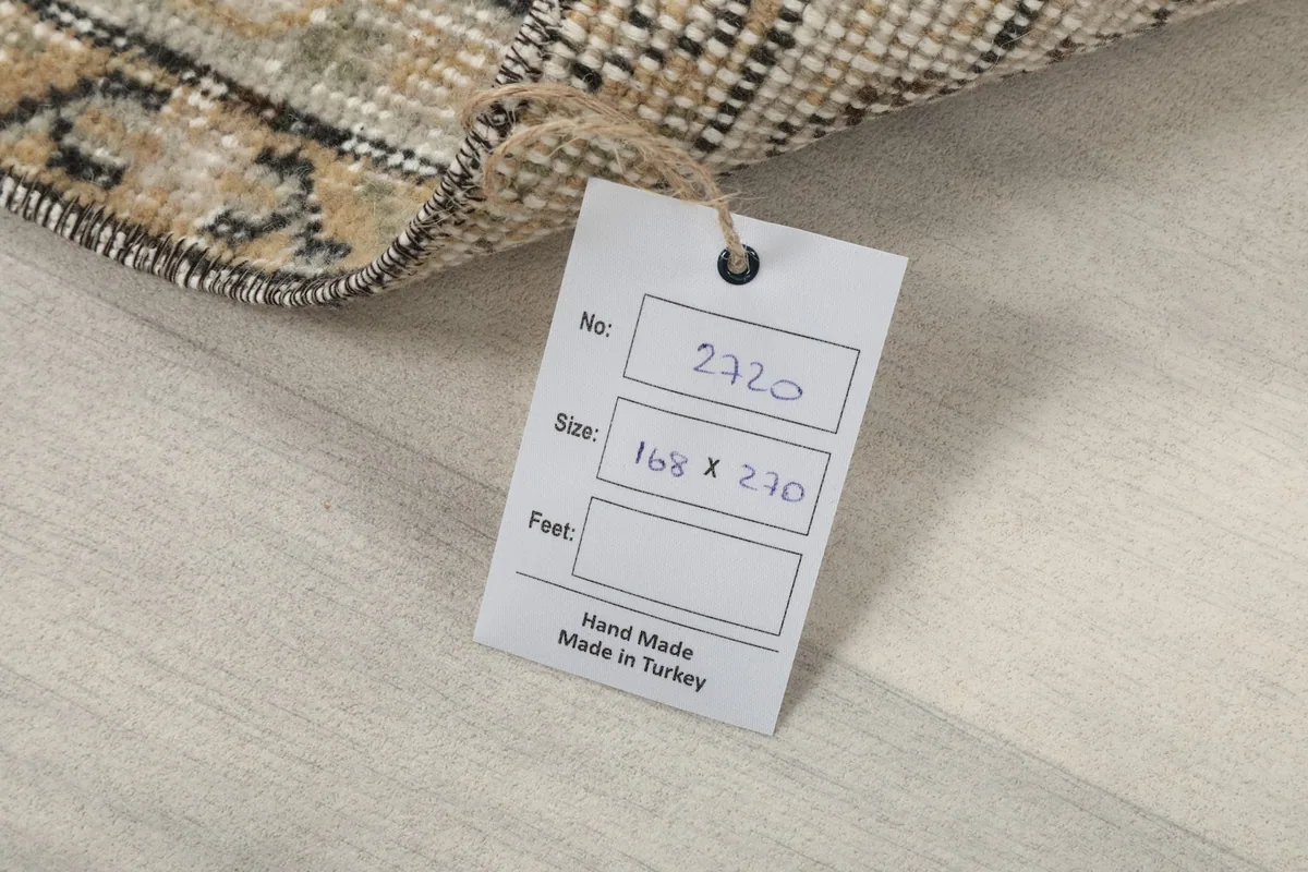 Close-up of the product tag attached to the rug, displaying size and origin
