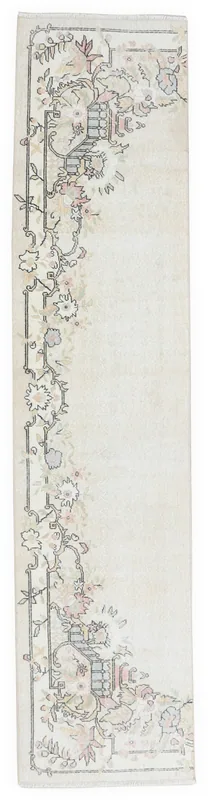 Full top view of the 2'7" x 10'7" ivory vintage Anatolian runner rug with floral geometric motifs.