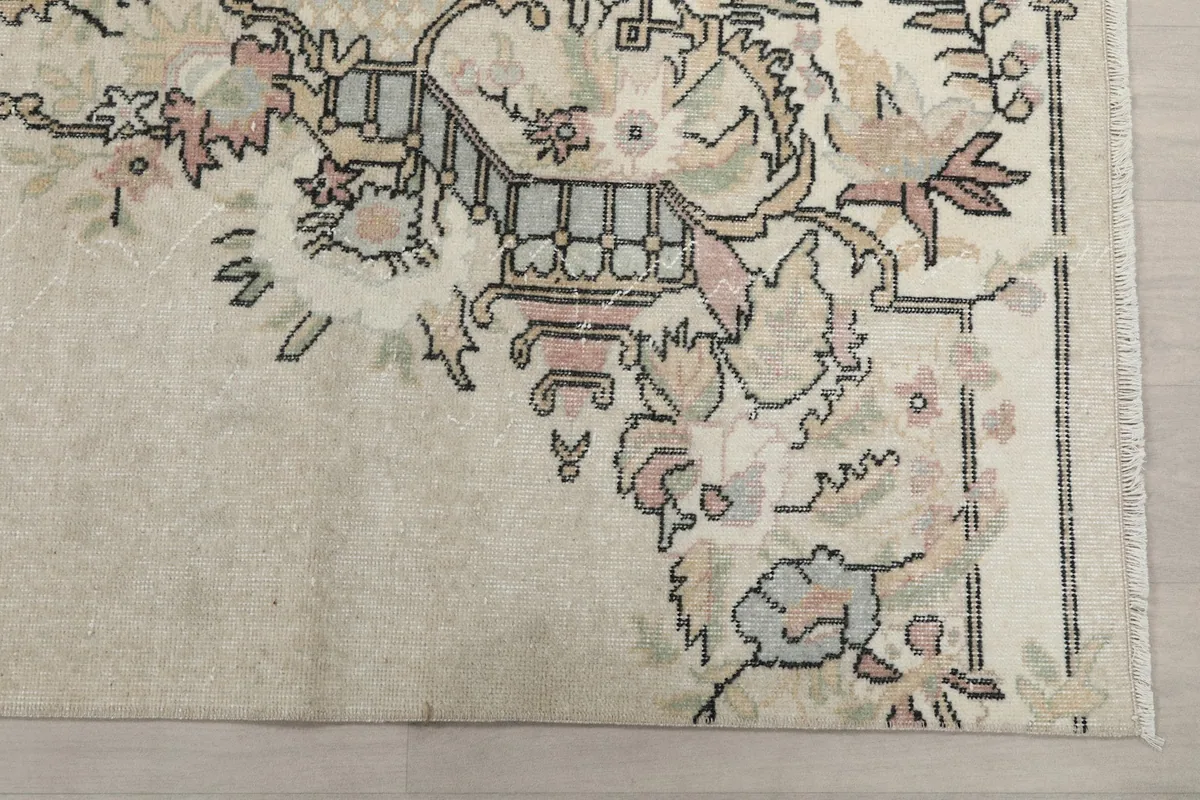Detailed view of the rug's corner, highlighting the intricate floral and geometric patterns.