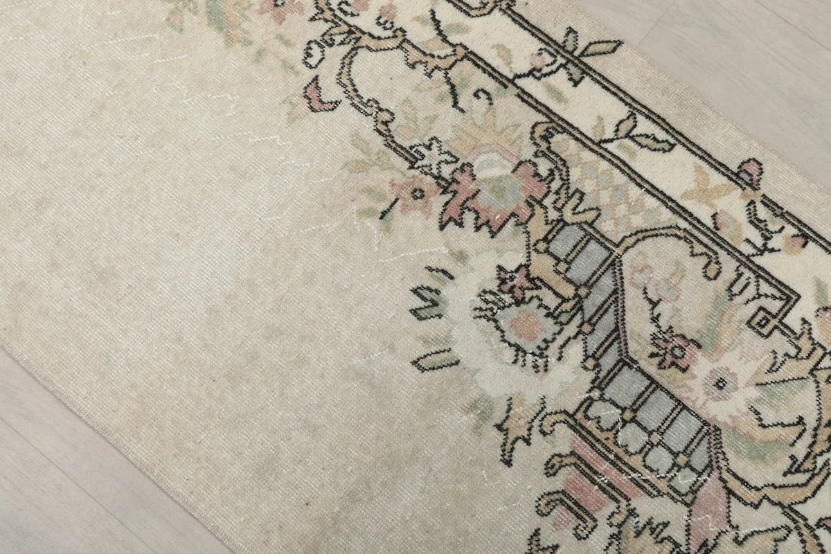 Close-up of the rug's central design, showing the subtle color variations and hand-knotted texture.