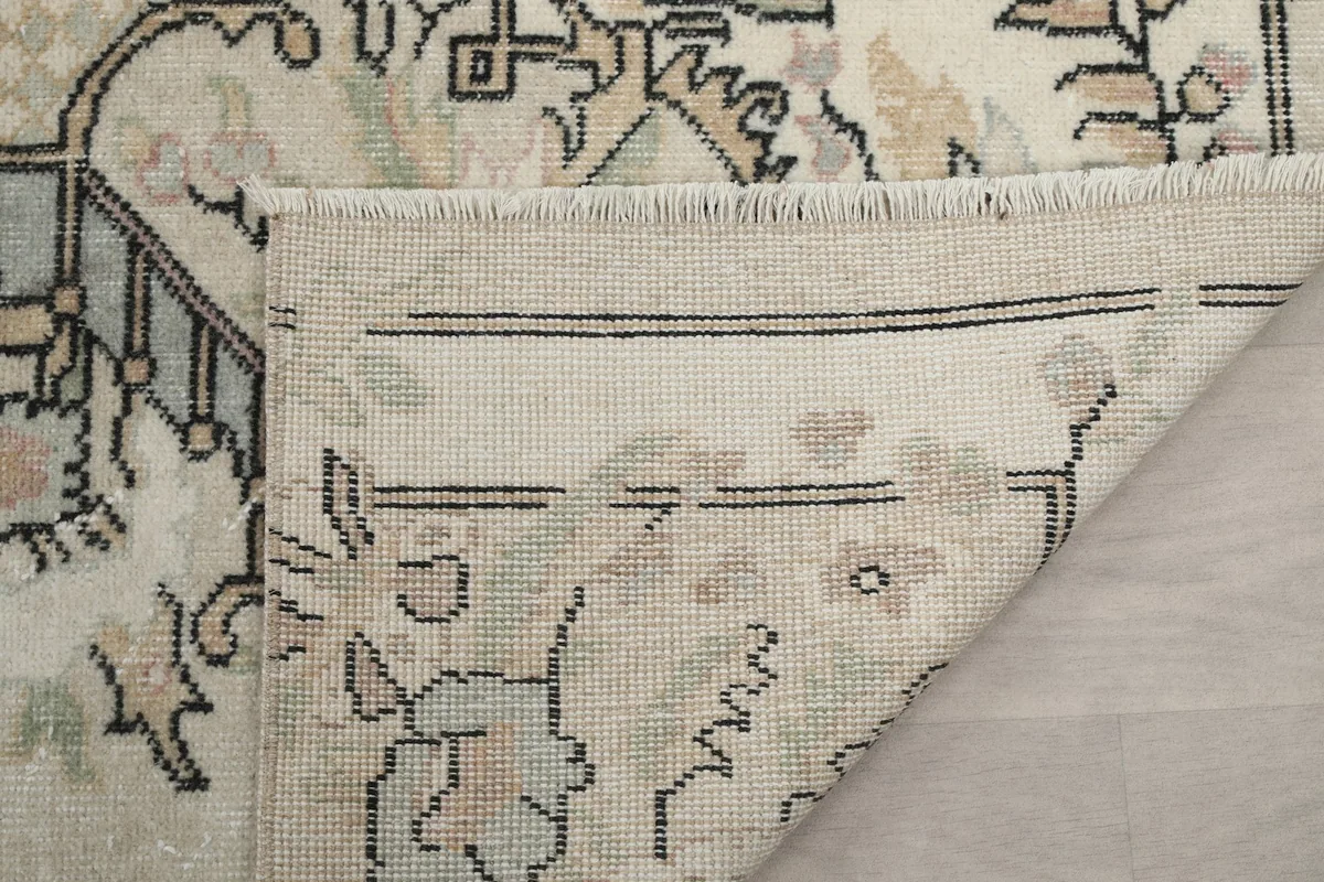 Underside of the rug's corner, showcasing the cotton foundation and construction.
