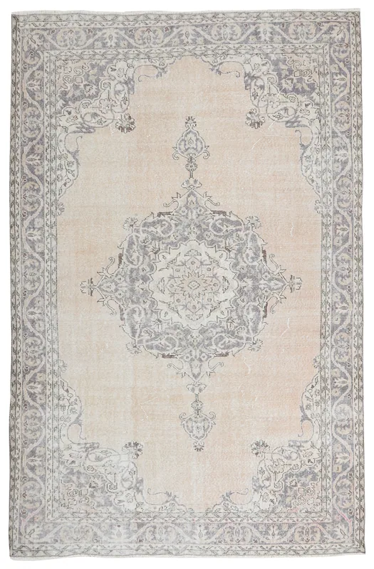Full top view of the 6'9" x 10'9" ivory and gray vintage Anatolian rug with central medallion