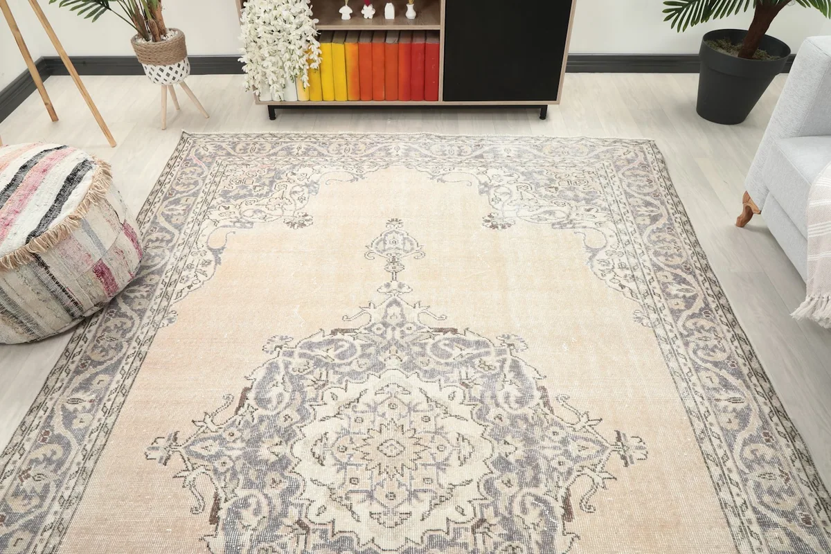 Overhead angle of the large ivory and gray vintage rug in a living room, highlighting its full design