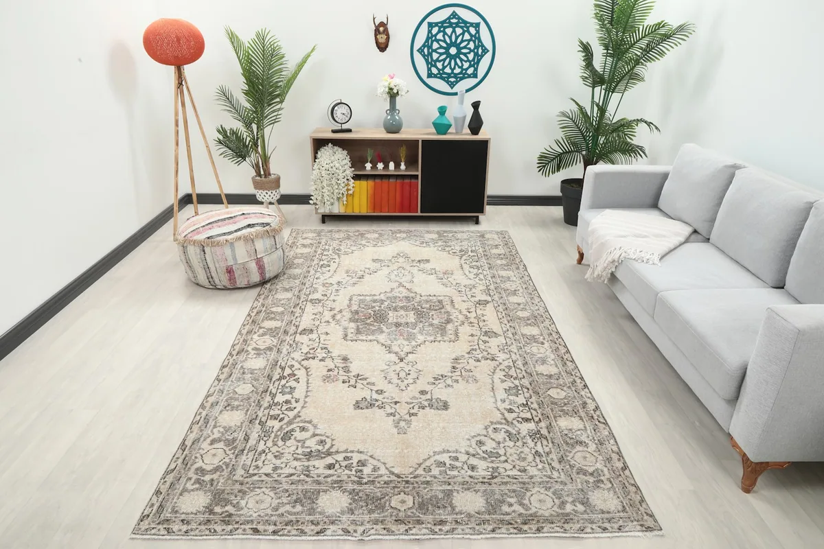Area rug displayed in a living room setting with a gray sofa and light wood flooring.