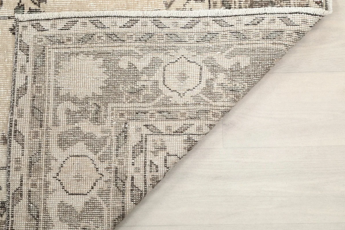 Close-up of the rug's back, revealing the knotting structure and craftsmanship.