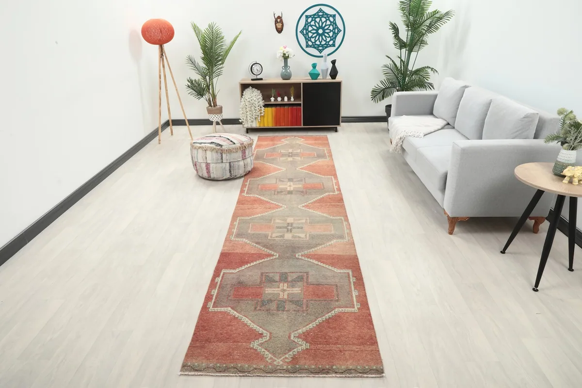 Vintage Anatolian runner rug with rust and gray colors in a modern living room setting