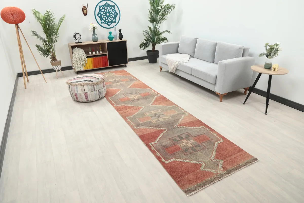 Angle view of the rust and gray geometric runner rug in a contemporary hallway
