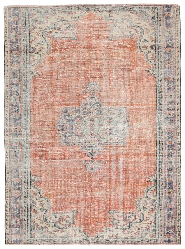 Full overhead view of the rust and blue vintage Anatolian rug on a white background