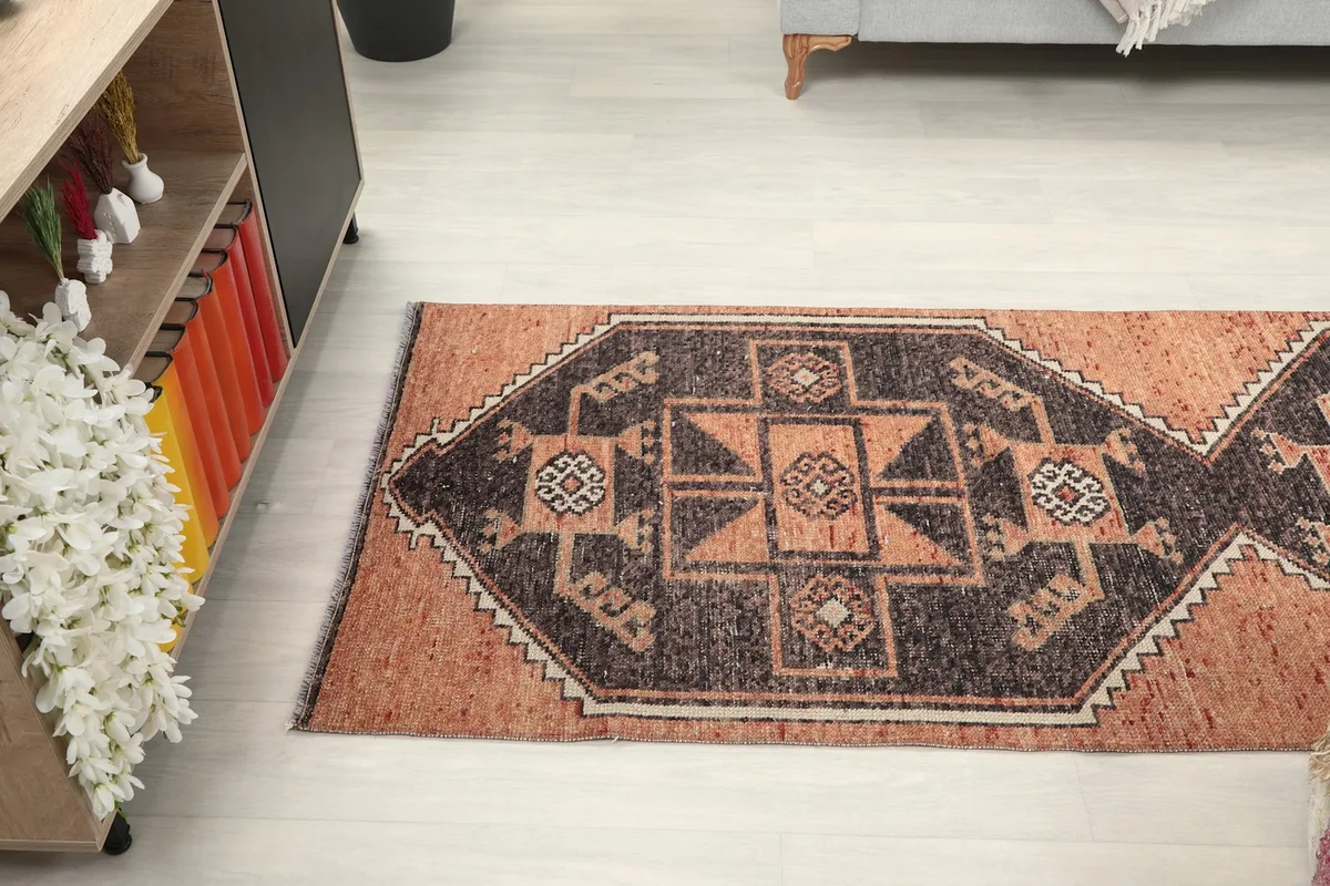 Angled view looking down the length of the runner rug, showing the repeating geometric design