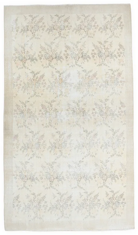 Full top view of the ivory floral vintage Anatolian rug on a white background