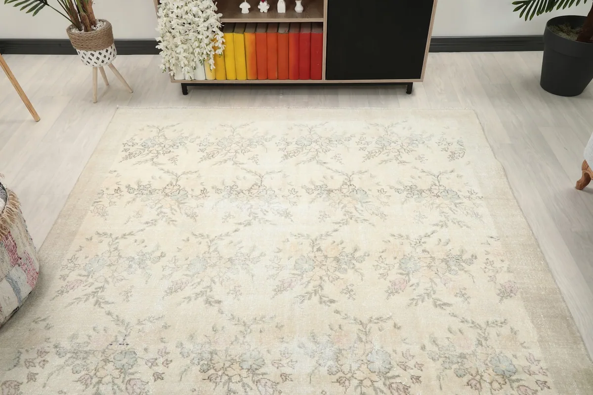 Overhead view of the ivory floral rug in a room, showcasing its full design