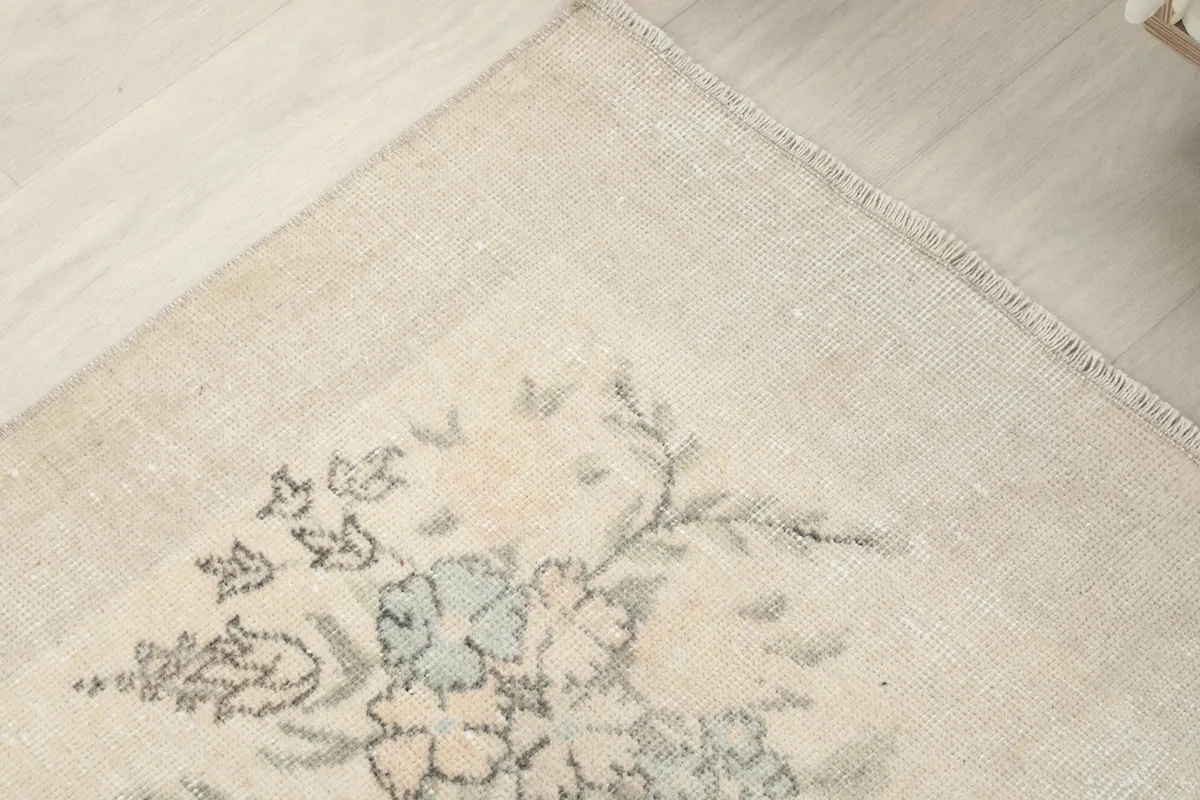 Corner detail of the rug, showing the fringe and the subtle blend of colors
