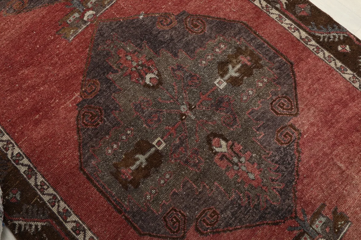 Close-up of a central gray geometric medallion with intricate details