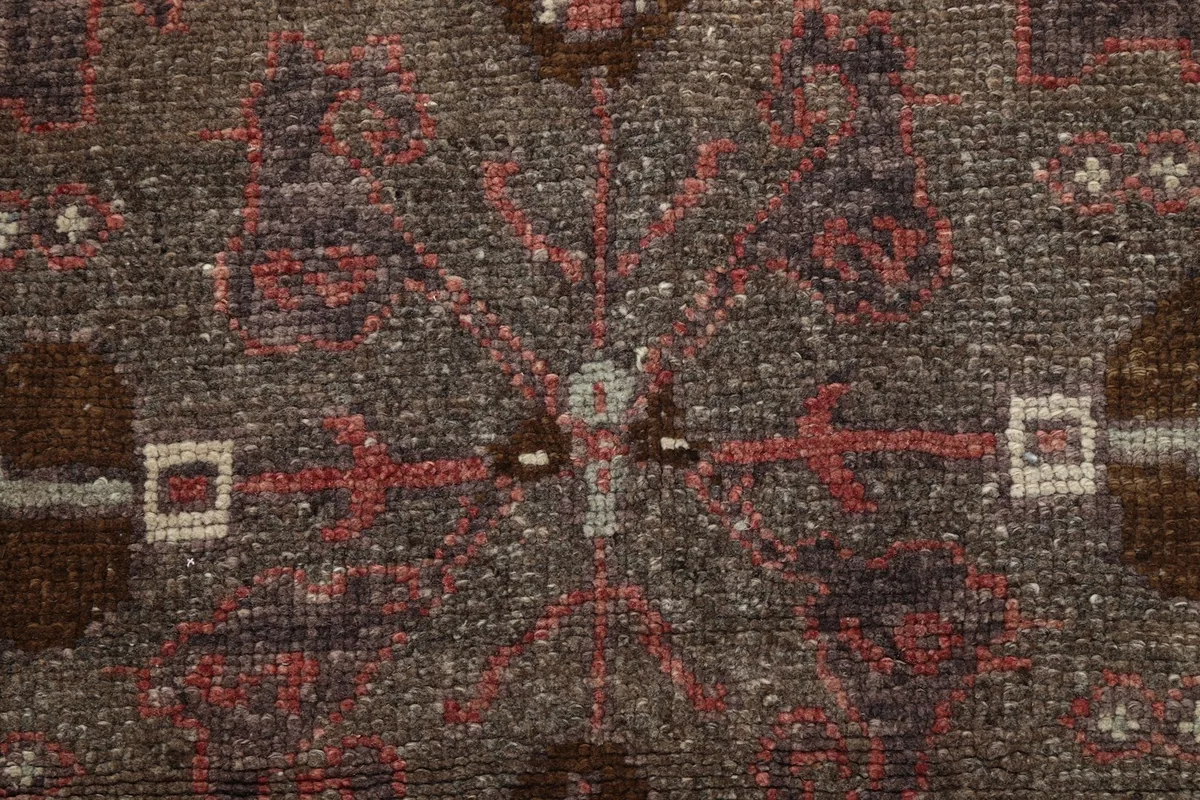 Macro view of the hand-knotted wool pile, showing texture and subtle color variations within a medallion
