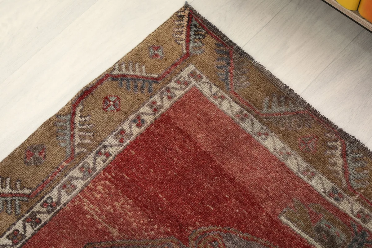 Corner of the rug folded to reveal the cotton foundation and reverse side of the knots