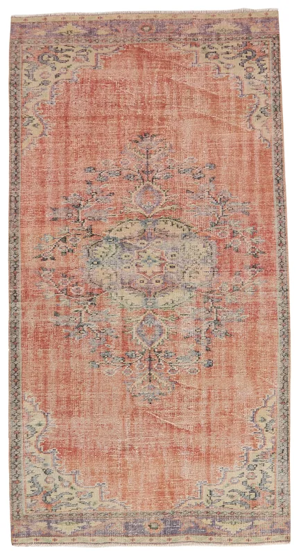 Full overhead view of the vintage rust area rug with a central medallion on a white background
