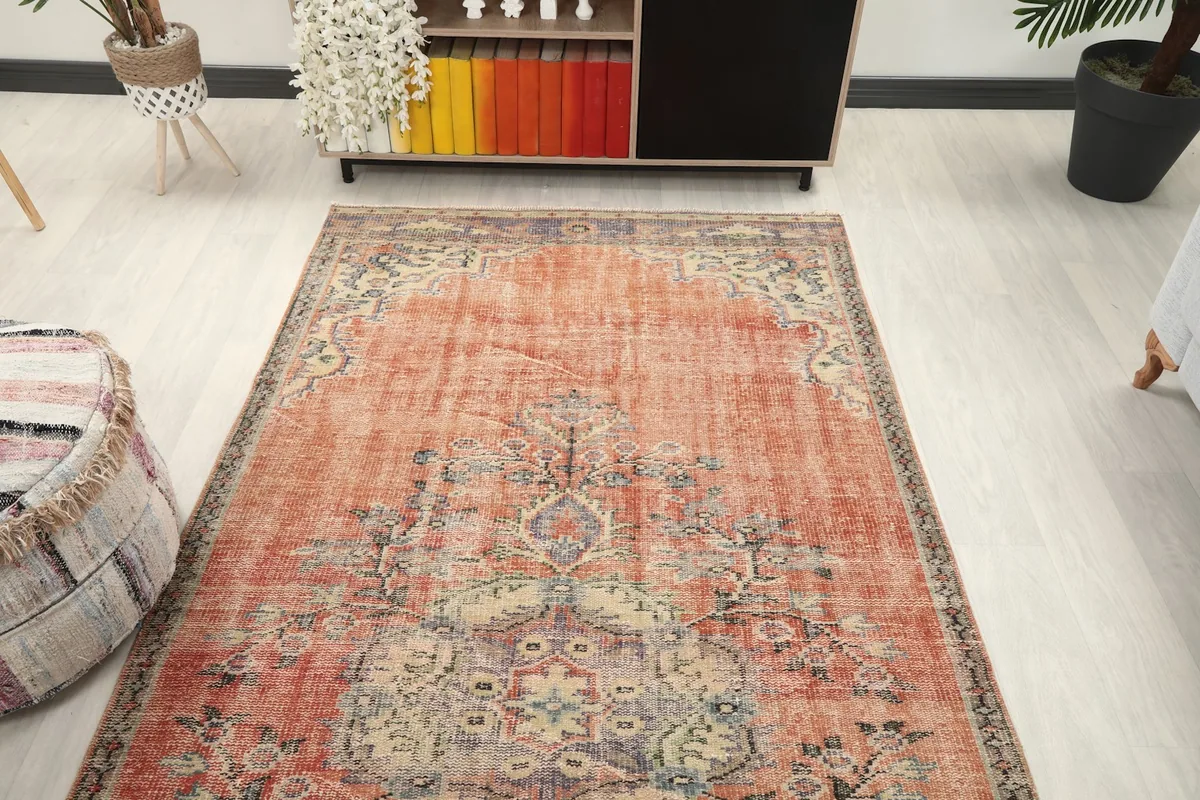 Overhead angled shot of the rug in a living room, showcasing its full design and colors